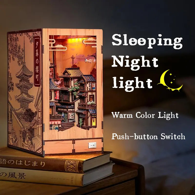 Bedside night light display of Twilight Sakura Path DIY Book Nook Kit, warm glow LED lamp with push button switch