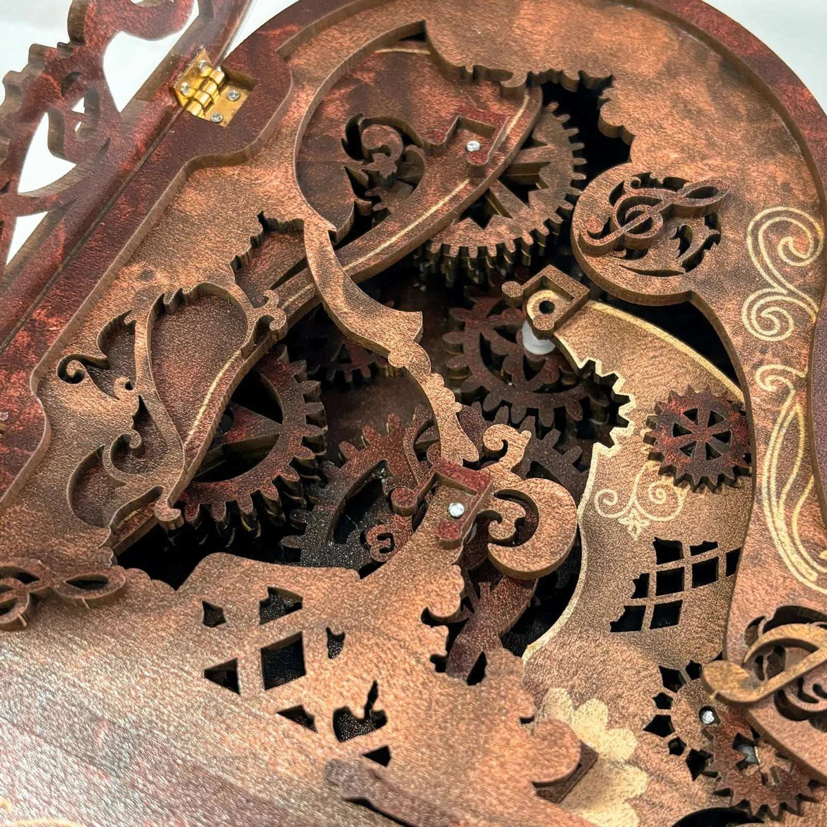 Interlocking wooden gears beneath the decorative lid of the 3D Piano model.