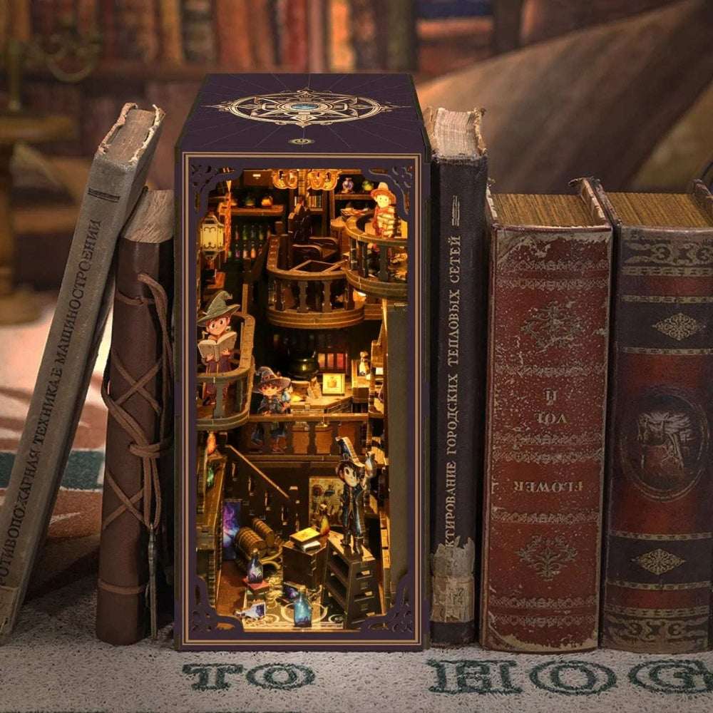 Alchemy Master book nook among books, with shelves, bottles and miniature laboratory equipment.