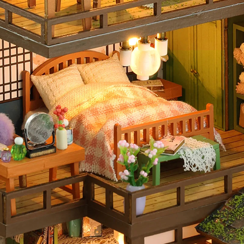 Bamboo Spring Courtyard upper bedroom with a peach-colored quilt and bedside lighting.