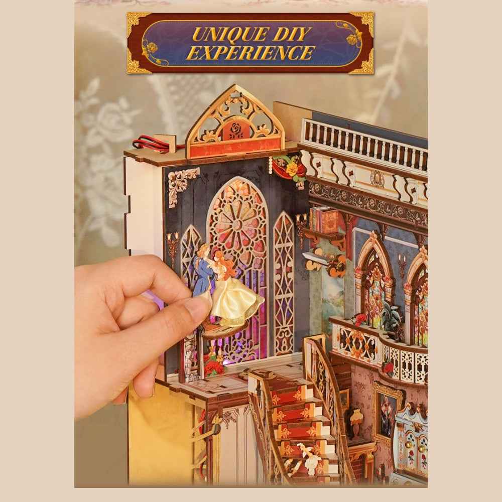 Hand placing a character piece inside the Beast and Beauty miniature ballroom.