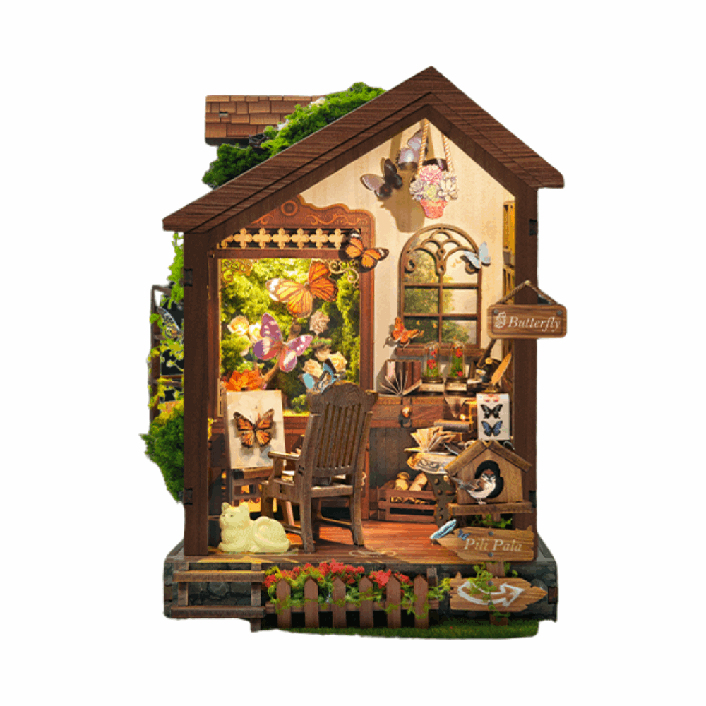 Front view of Butterfly House showing its butterfly display, rocking chair and garden fence.