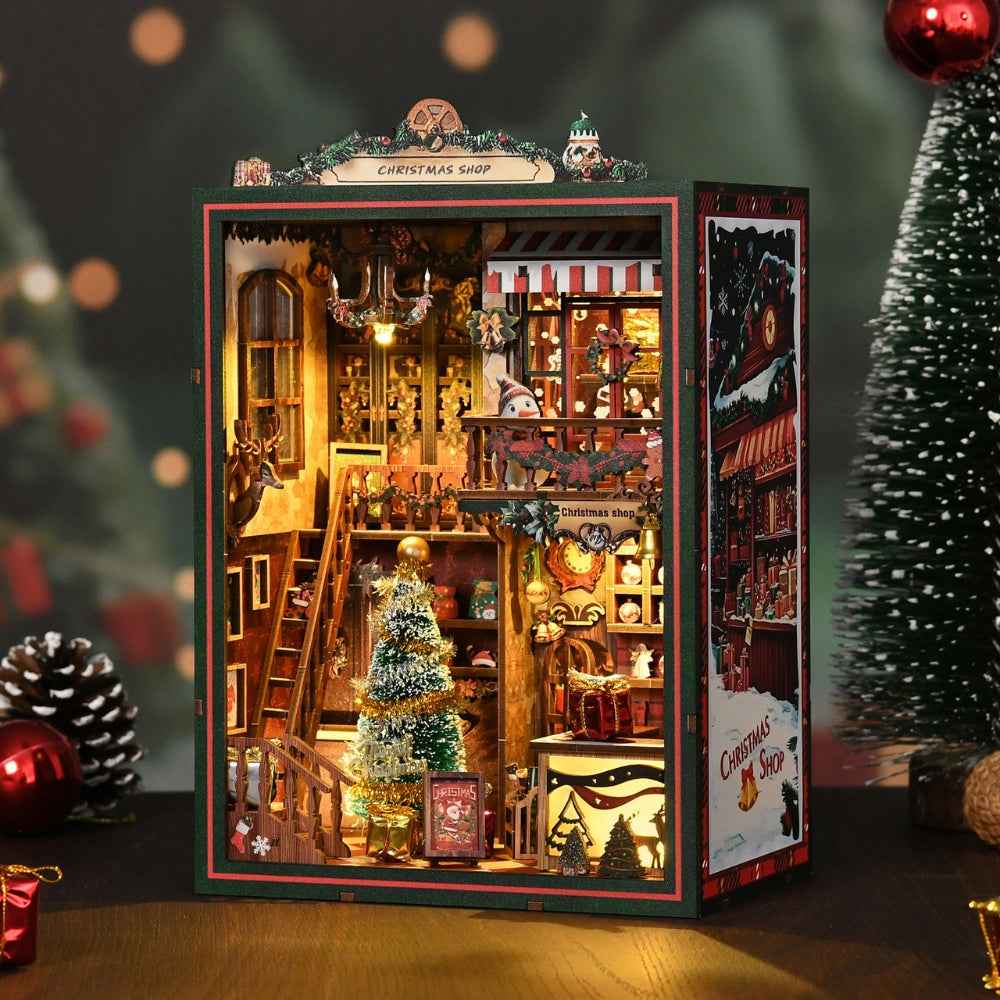 Christmas Shop book nook with a miniature Christmas tree, staircase and festive shelves.