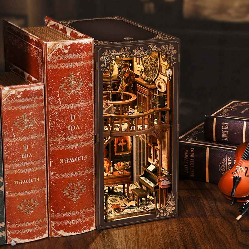 Dark Box Mystery Case book nook beside red books, with a miniature study and curved balcony.