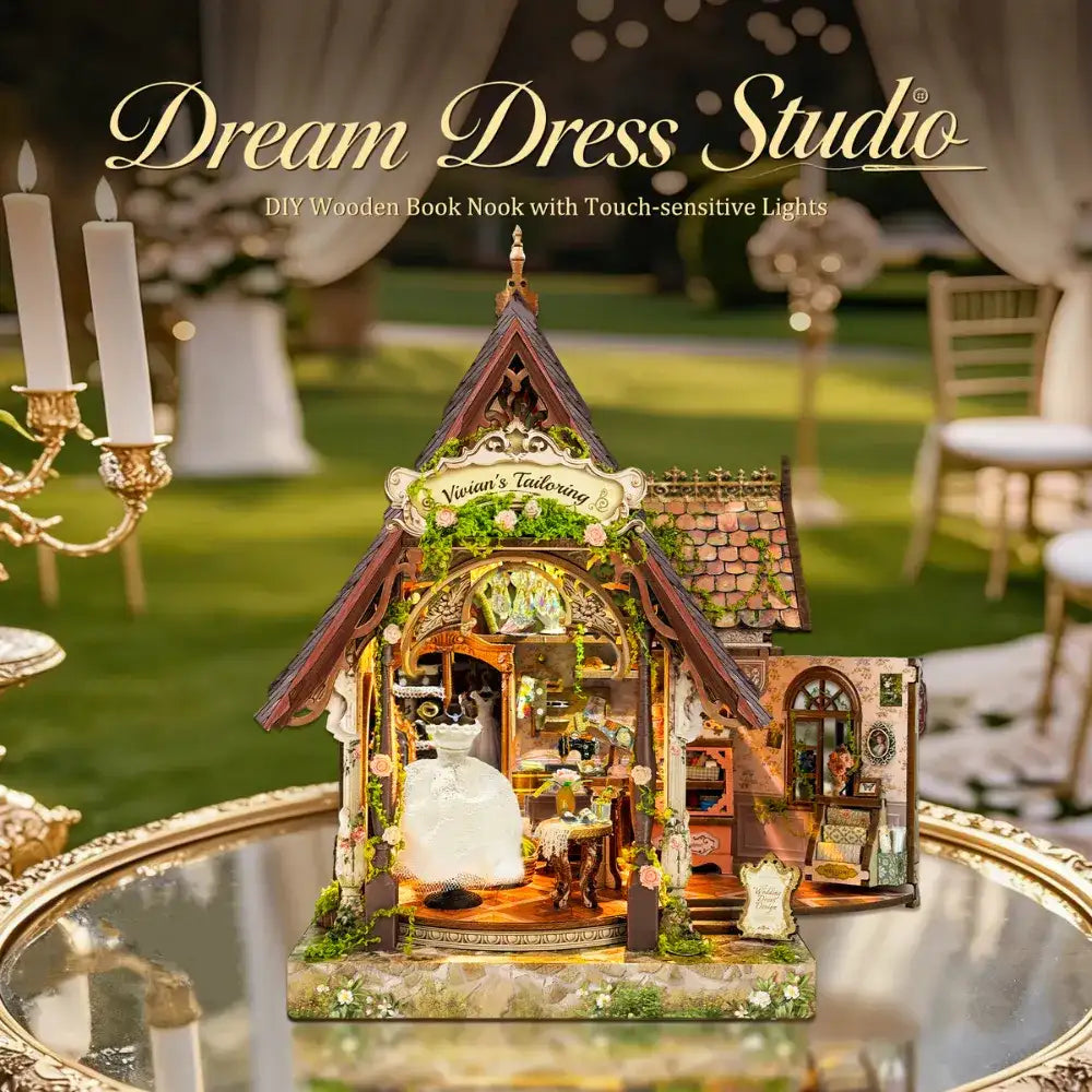Dream Dress Studio on a reflective tray in a garden setting, with warm interior lighting.