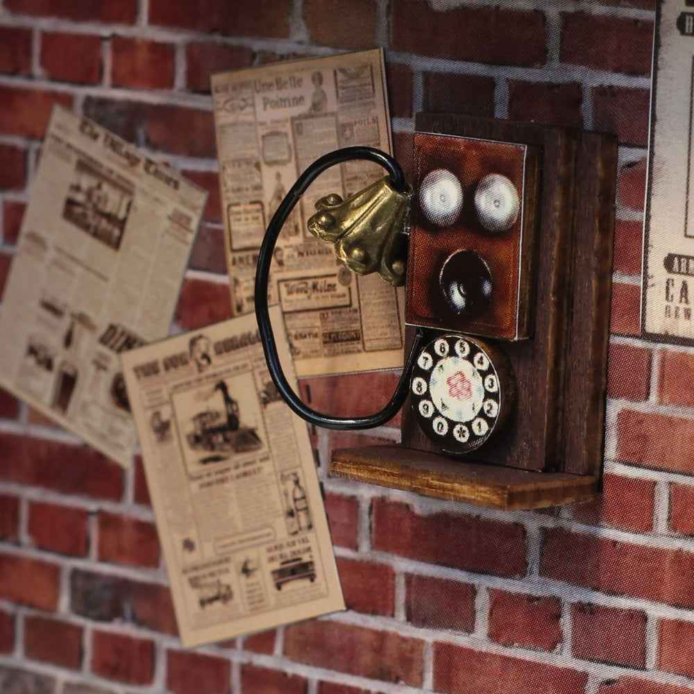 Miniature wall telephone and newspaper notices on the Fancy Train Platform brick wall.