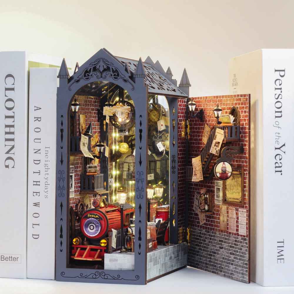 Fancy Train Platform book nook between books, with its side door open beside the locomotive.
