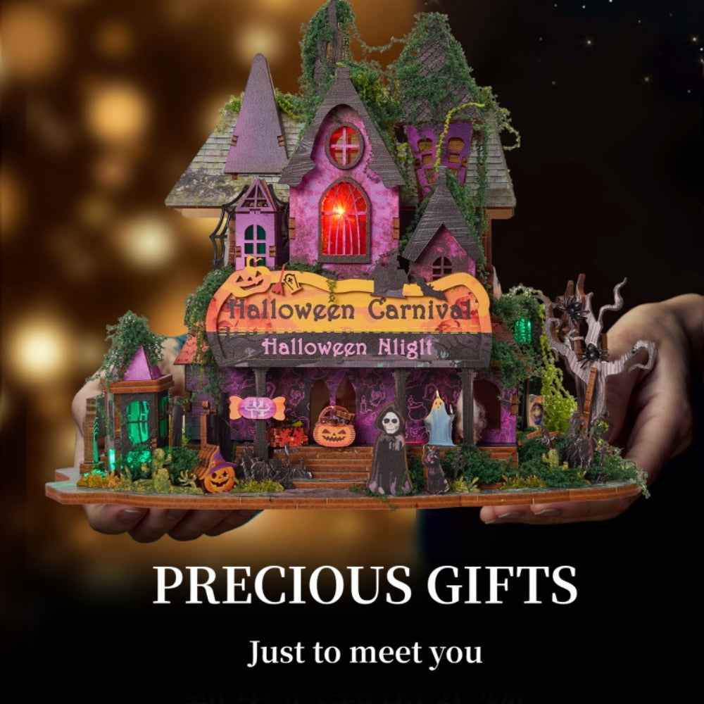 Hands holding the Halloween Night miniature house against a dark background.