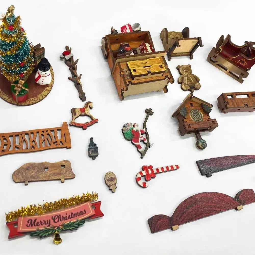 Jingle Cabin miniature components arranged separately, including a tree, bench, drawers, snowman and Santa.