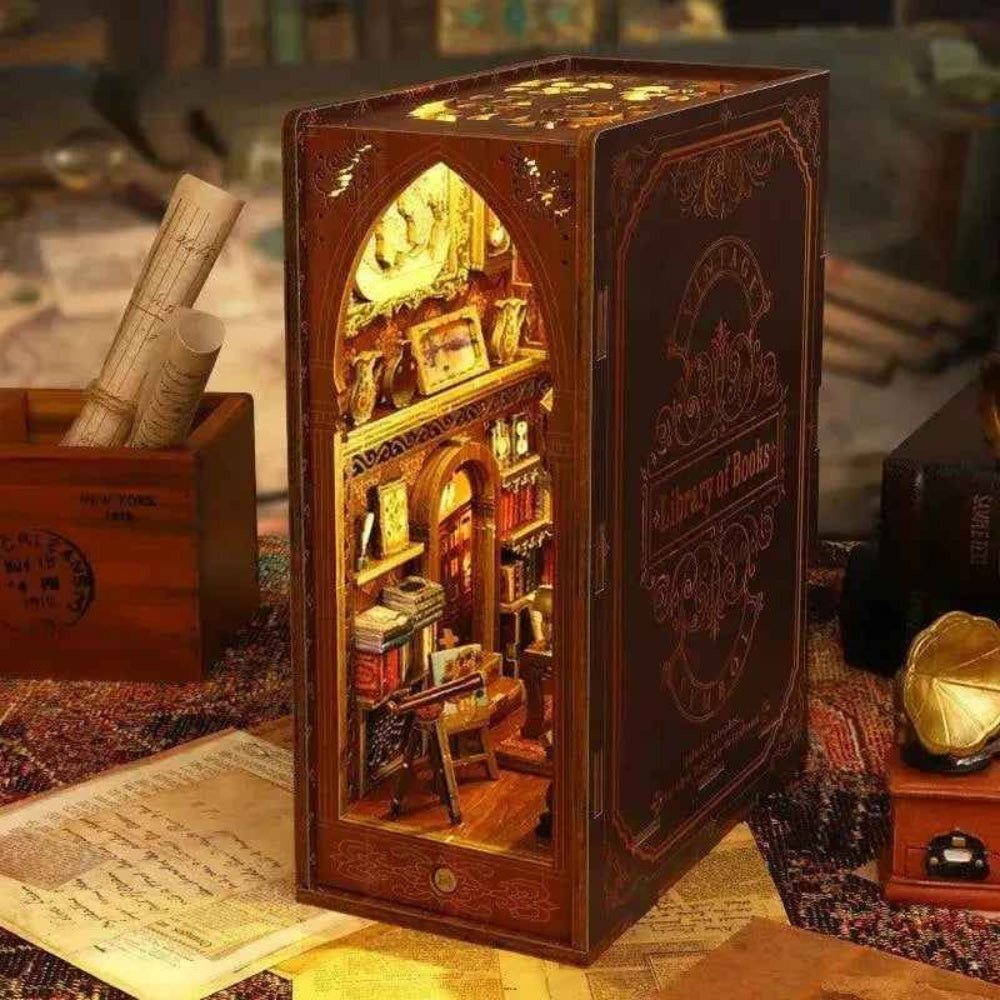 Angled view of the illuminated Library of Books miniature library on a desk.