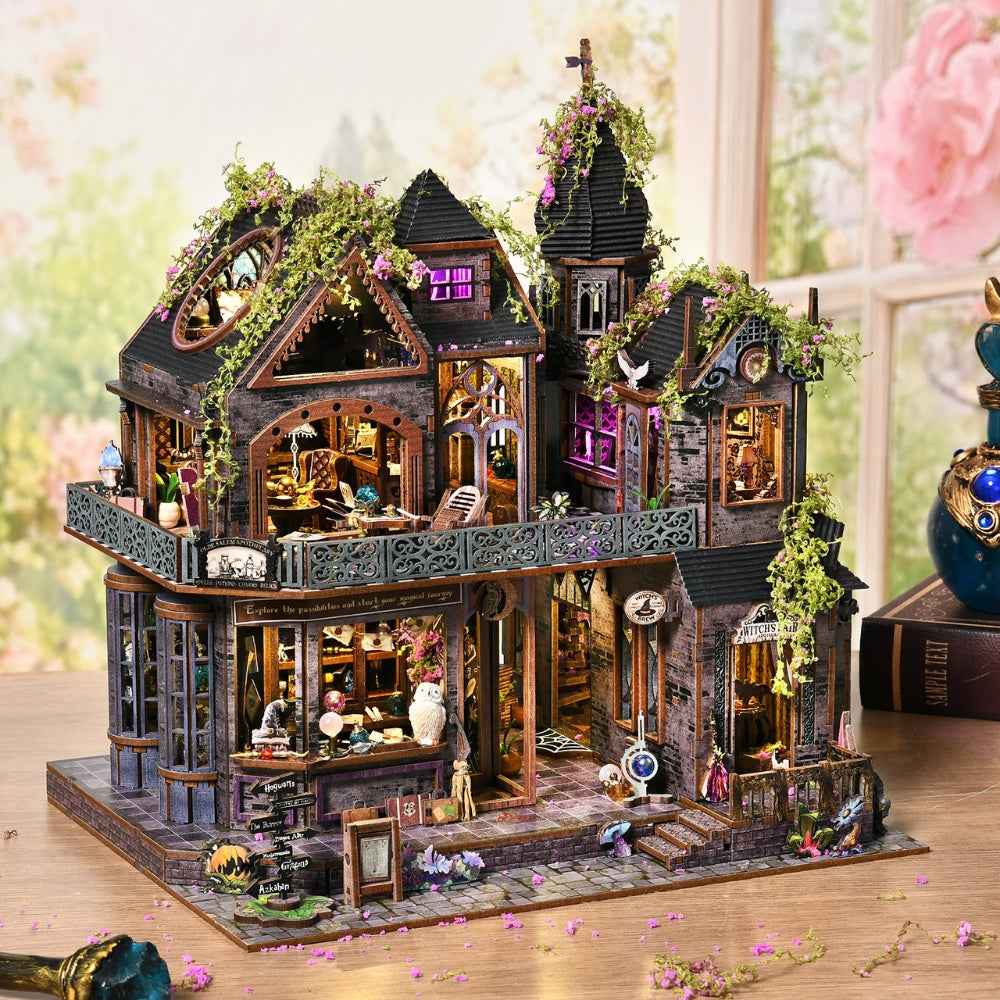 Magic Castle miniature house with climbing greenery, pointed towers and purple-lit windows.