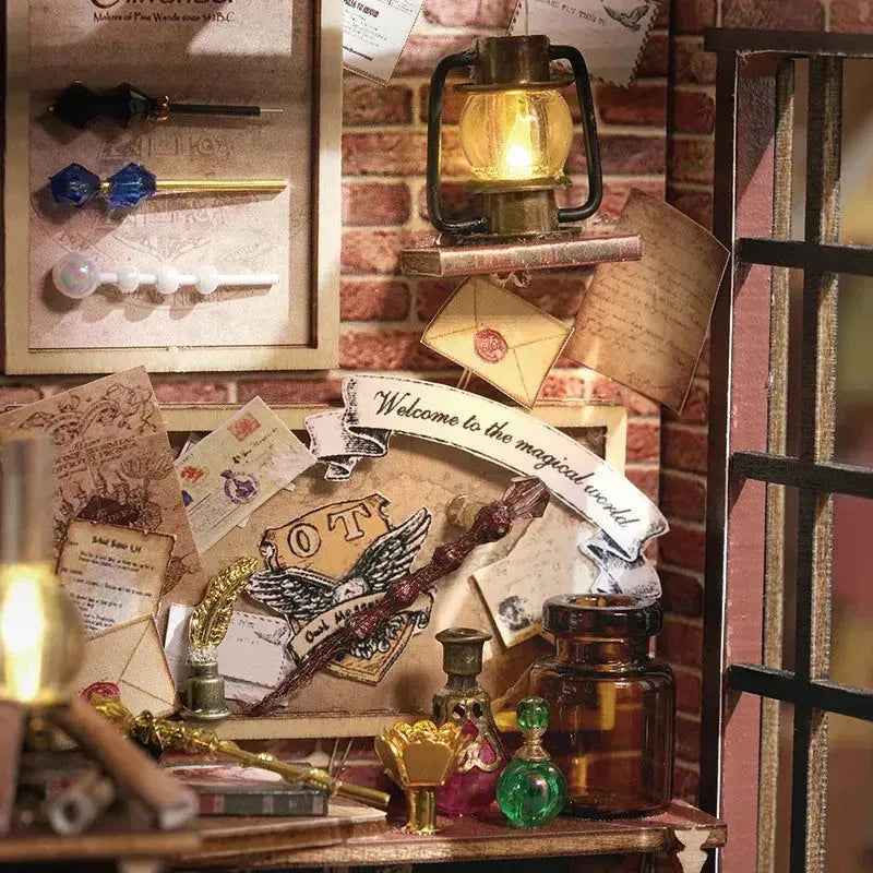 Magic House wall lantern and scroll letter beside a miniature wand display.