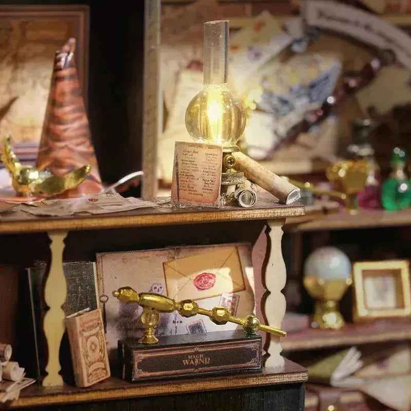 Wizard's hat and miniature desk with letters, boxes and a quill inside Magic House.