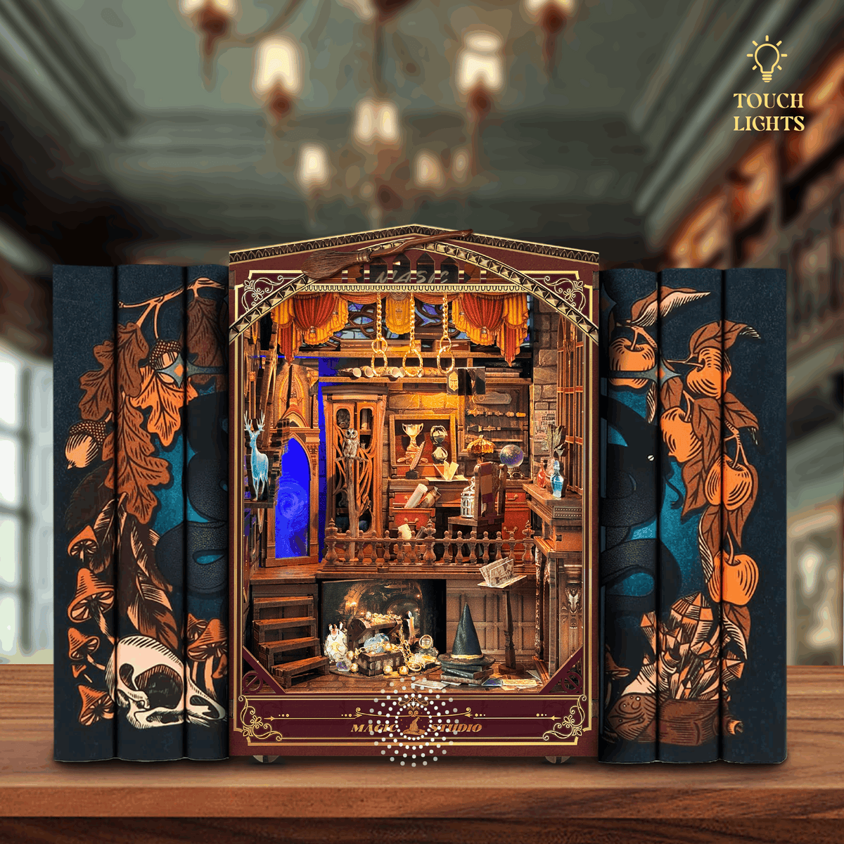 Magic Studio book nook between books with a miniature magician's workshop and blue-lit mirror.