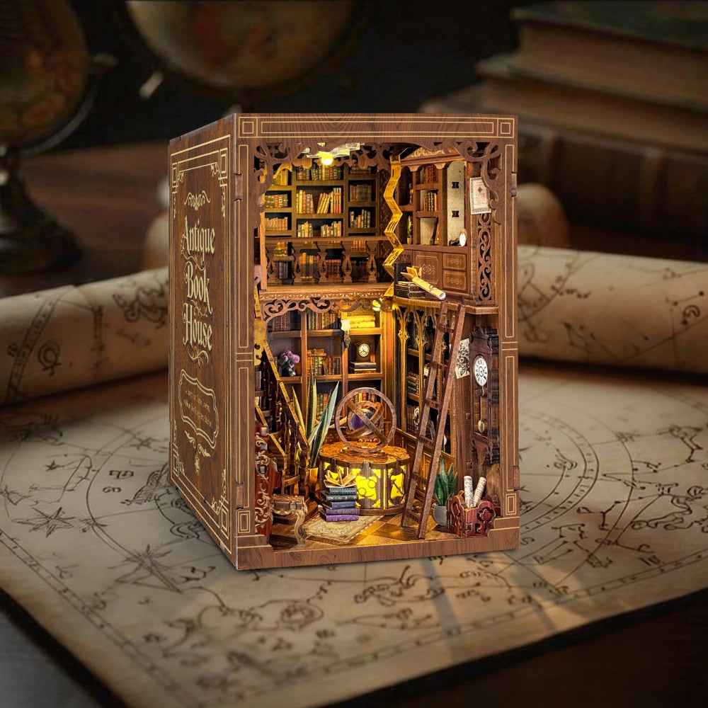 Myriad Books House book nook on an illustrated map, showing miniature shelves and a hanging lamp.
