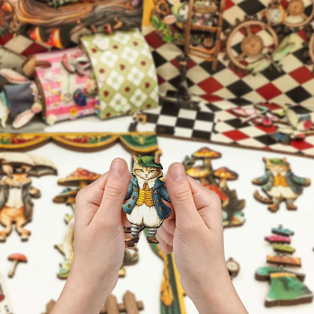 Hands holding a cat puppet piece beside other Puppet Theater components.