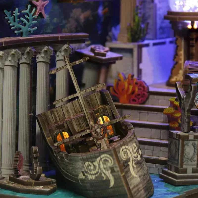 Open treasure chest beside miniature stairs and coral inside Riddle on the Seabed.