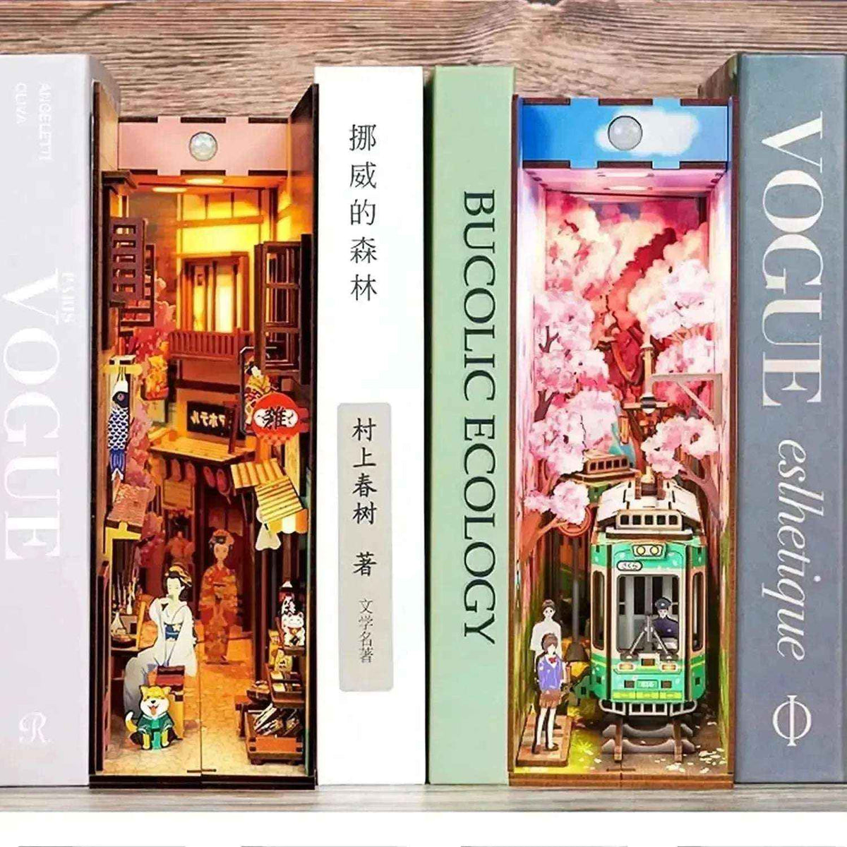 Sakura's Travel cherry-blossom book nook displayed beside another illuminated miniature street scene.