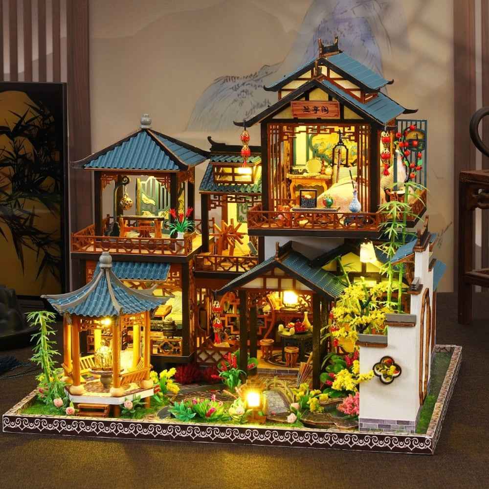 Serenade of the Orchid Garden miniature courtyard with blue-roofed pavilions and warm lights.