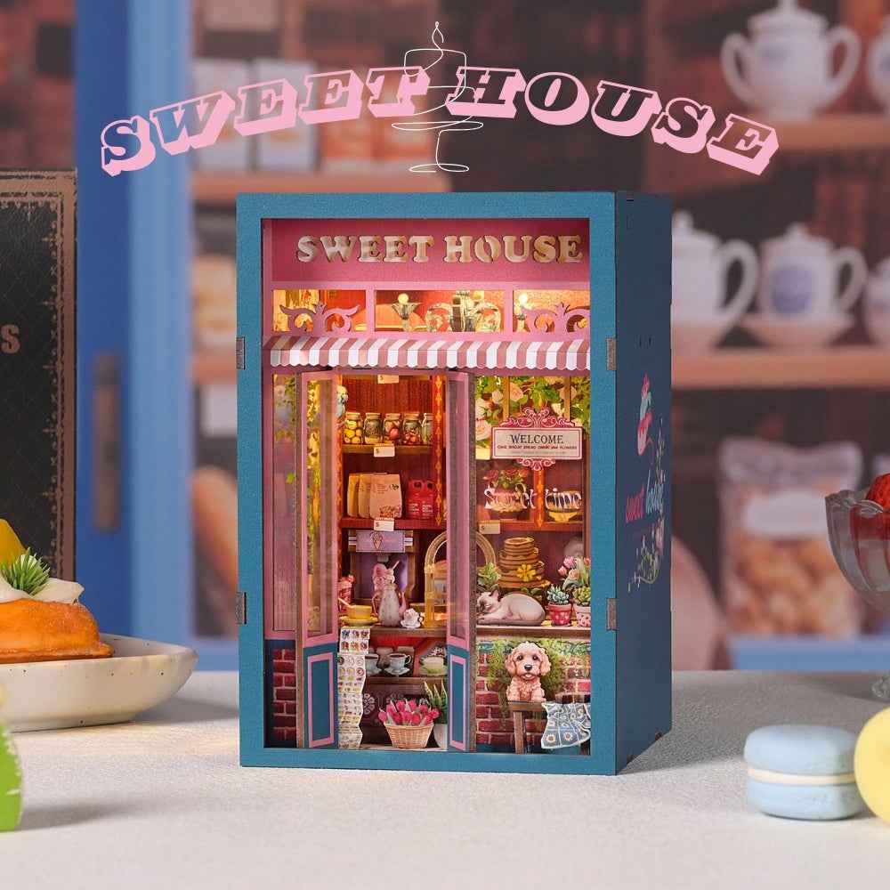 Sweet House book nook with a striped bakery awning and warm-lit pastry displays.