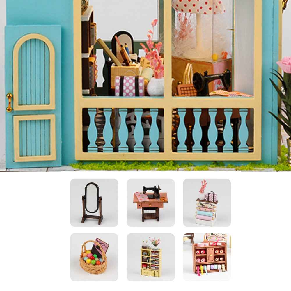 Tailor Shop façade detail with miniature mirror, sewing table and shelving pictured below.