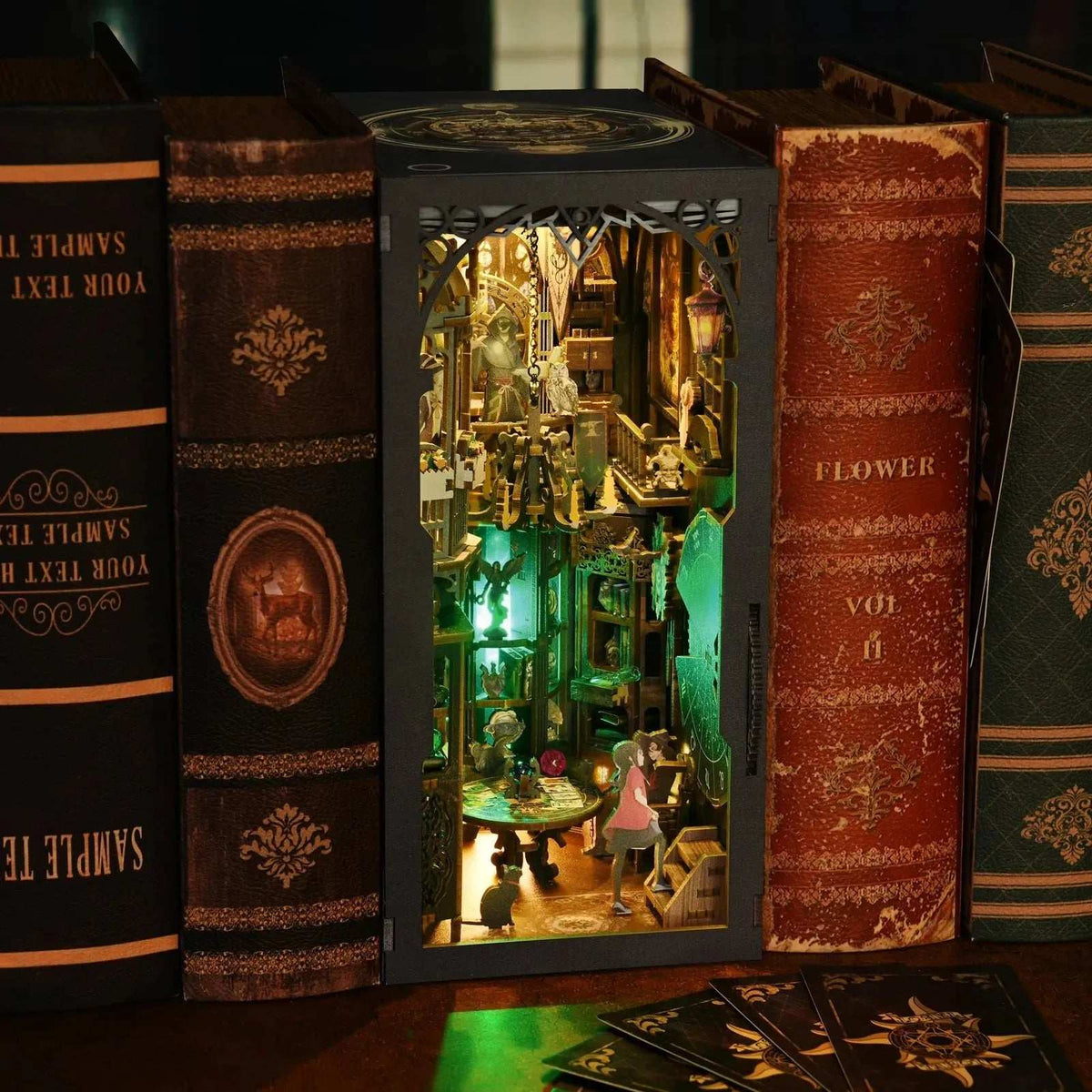 Tarot Divination Society book nook between books, showing its illuminated two-level interior.
