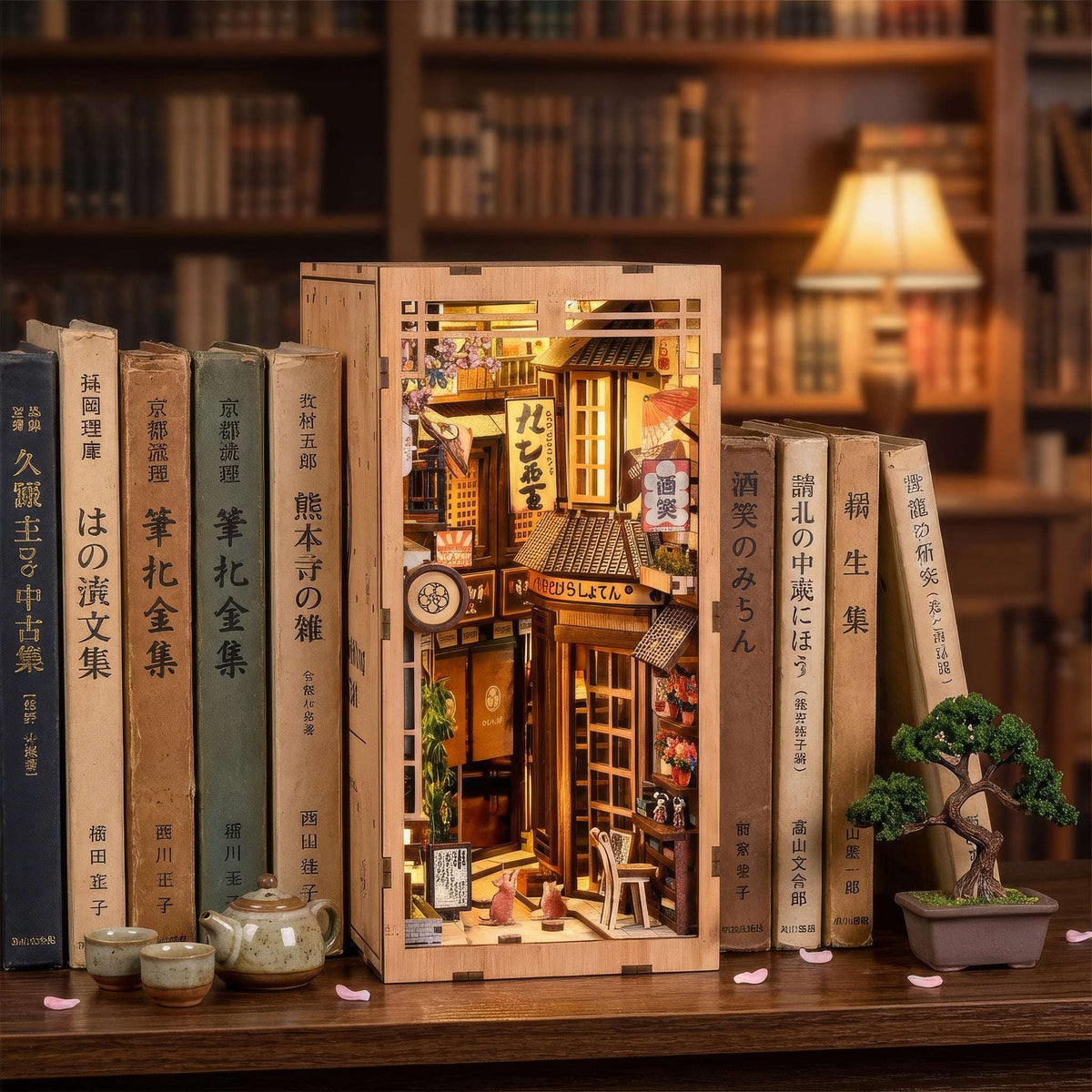 The Alley Waiting for the Cat book nook among books, showing a narrow Japanese shop-lined alley.