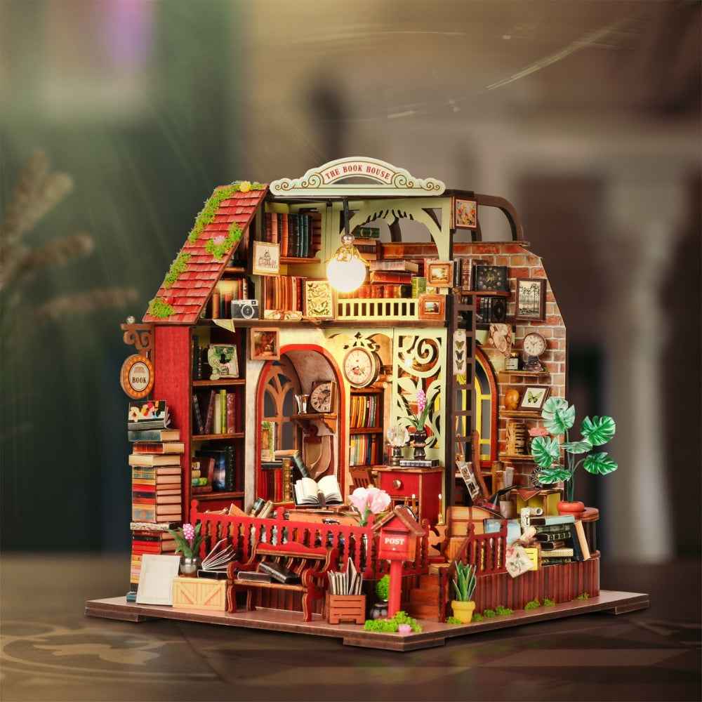 The Book House miniature building with red stairs, curved roof details and shelves of tiny books.