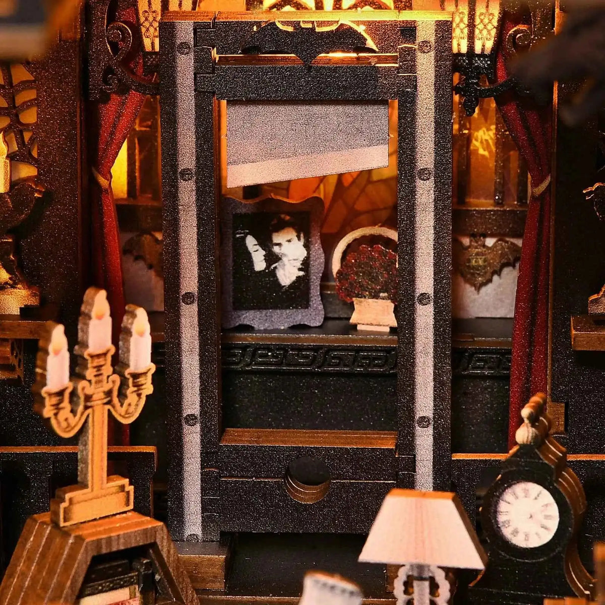 Miniature guillotine, candelabrum and clock inside The Dark Family book nook.