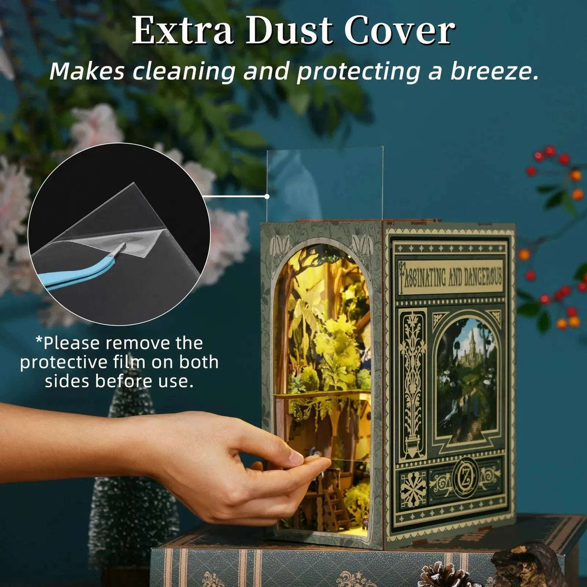 Hand removing the clear front cover from The Wizard of Oz book nook.