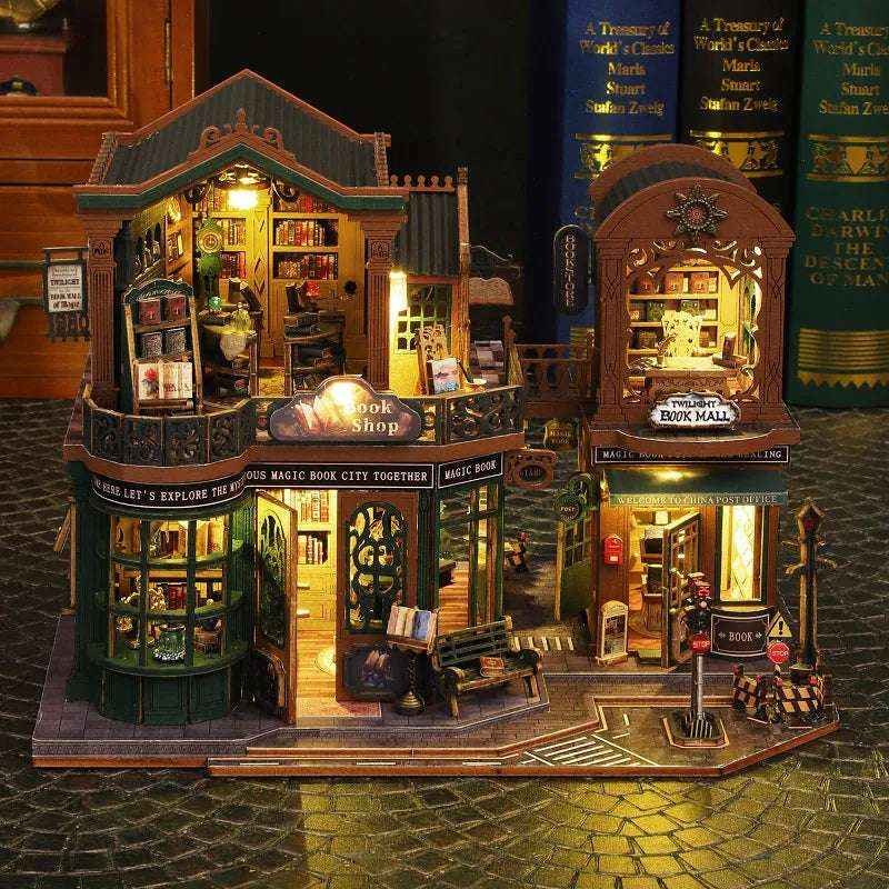 Front view of Twilight Book Haven with two-story bookshops, lit windows and miniature street furniture.