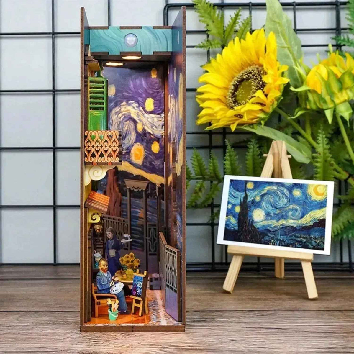 Vincent's World book nook displayed beside sunflowers and a small Starry Night painting.