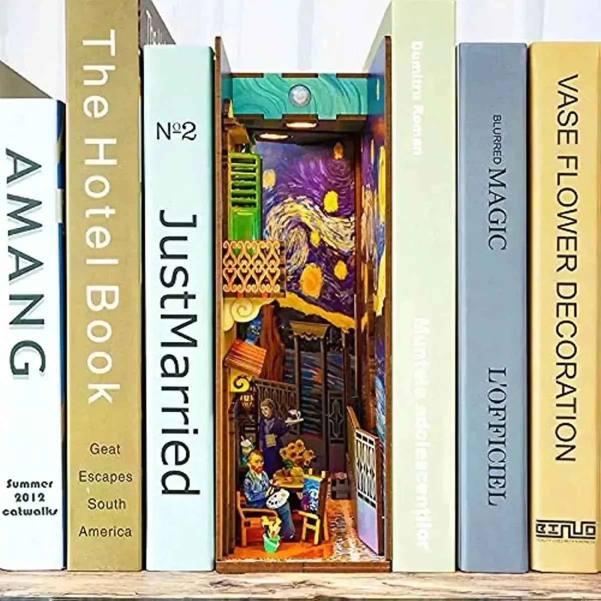 Vincent's World book nook between books, with a starry sky above a miniature café.