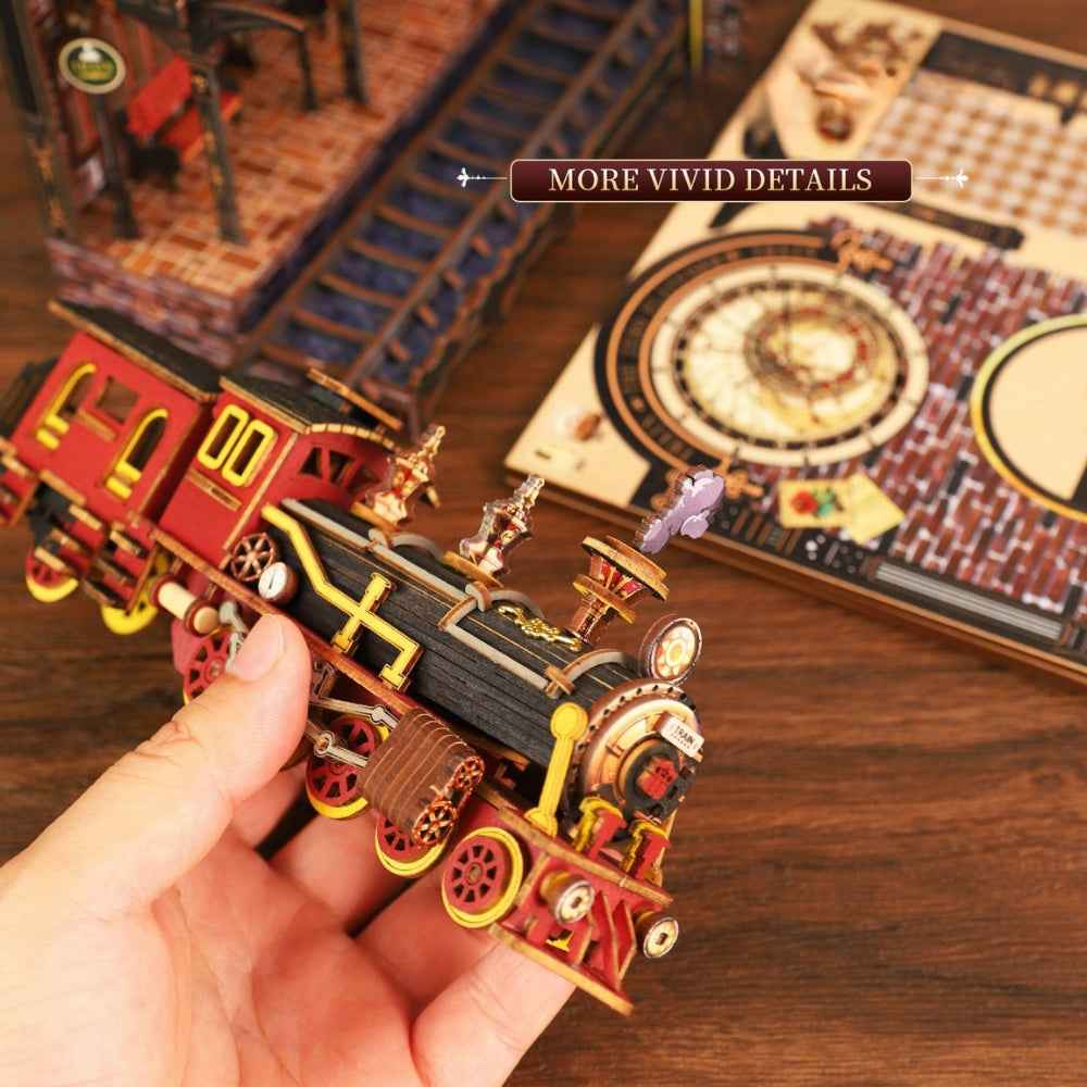 Hand holding the Zero Platform locomotive beside the station and clock panels.