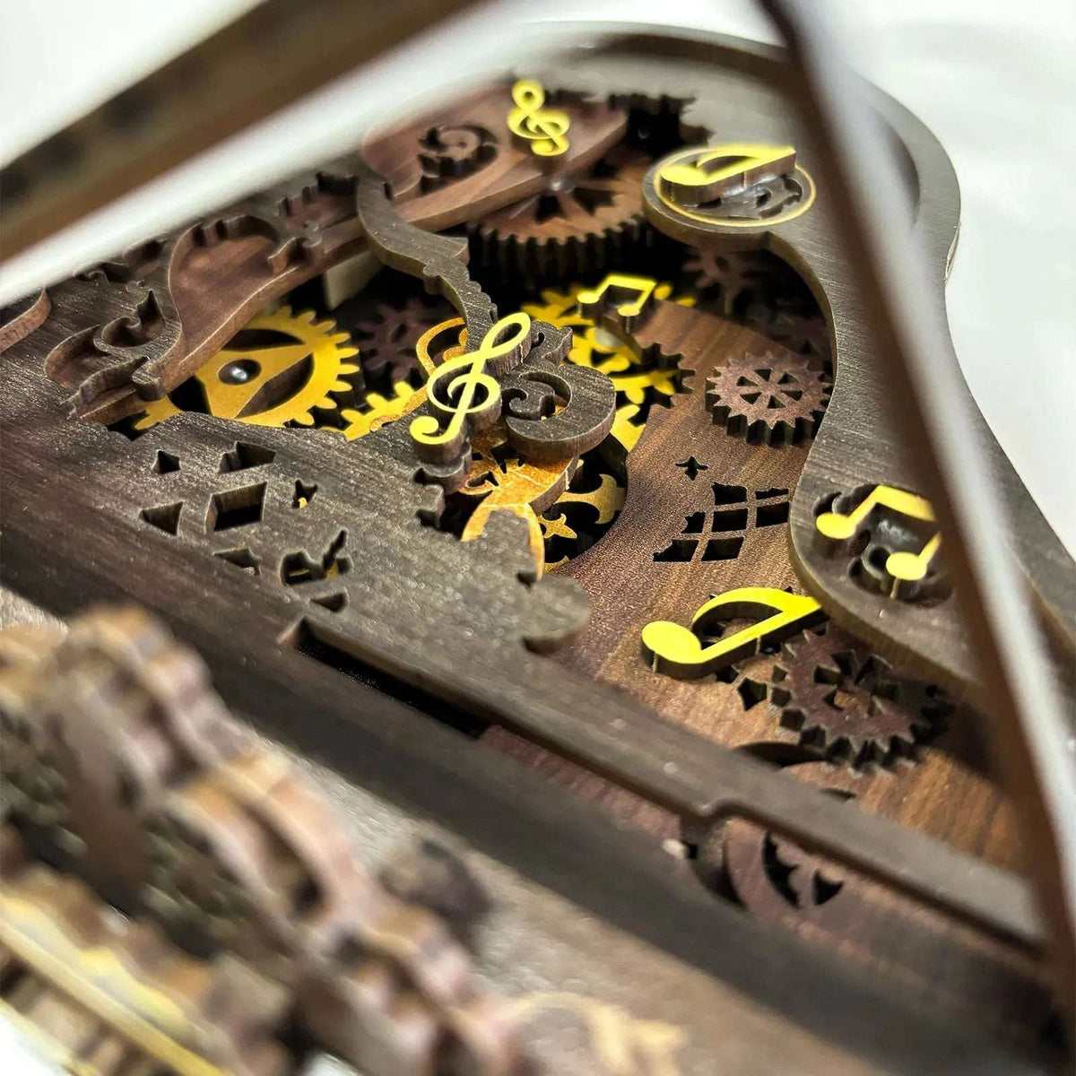 Musical-note decorations on exposed gears inside the 3D Piano wooden model.