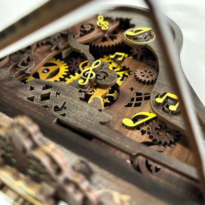 Musical-note decorations on exposed gears inside the 3D Piano wooden model.