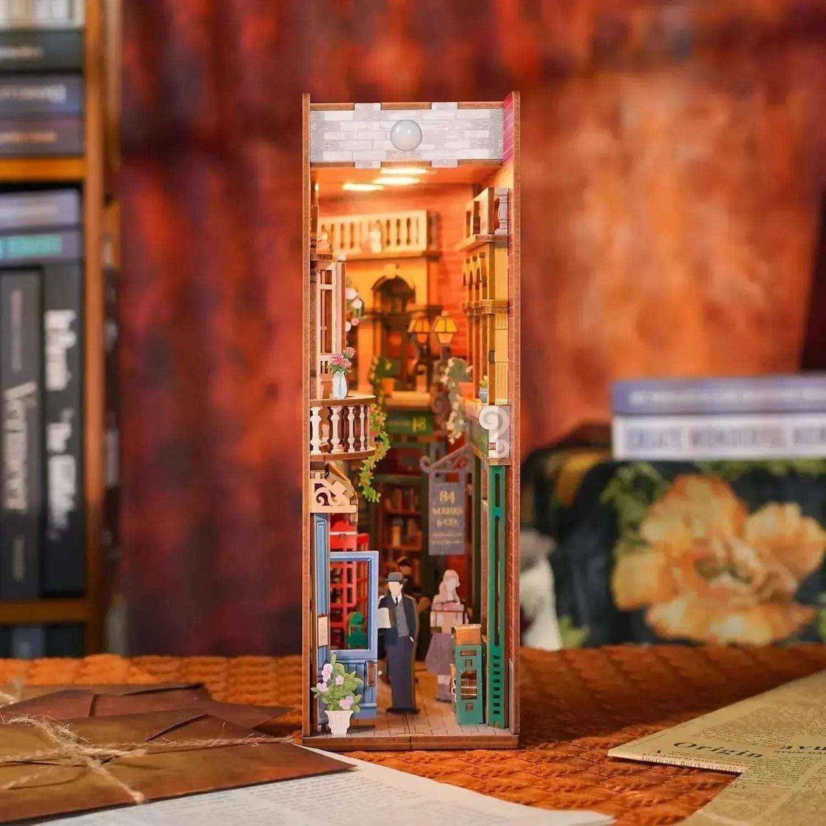 Illuminated 84 Charing Cross Road book nook with a miniature London bookshop and street scene.