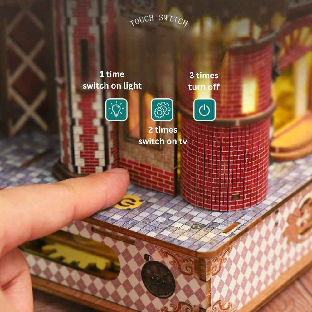 Finger pressing the Annecy Castle touch-control button beside its red tower.