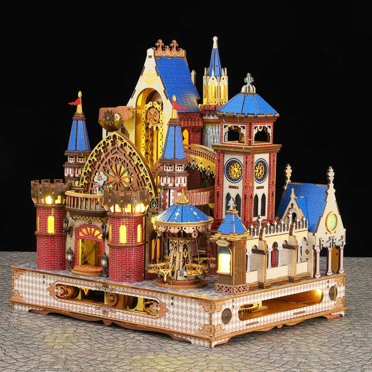 Annecy Castle miniature model with blue-roofed towers, warm lighting and a decorated base.