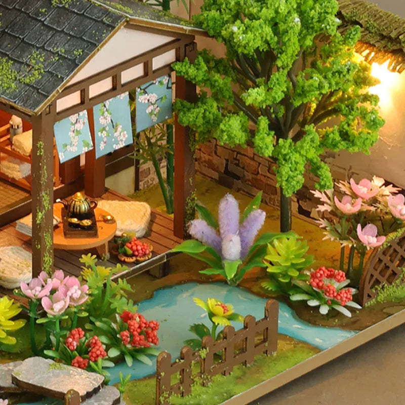 Bamboo Spring Courtyard garden with a pavilion, tiny bridge, trees and flowers.