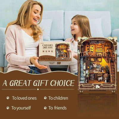 A woman and girl with the Caramel Dreams kit box and completed miniature cat café.