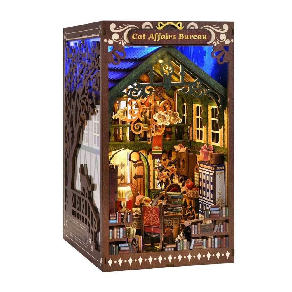 Cat Affairs Bureau opened book nook showing a chandelier, tiny books and cat figures.