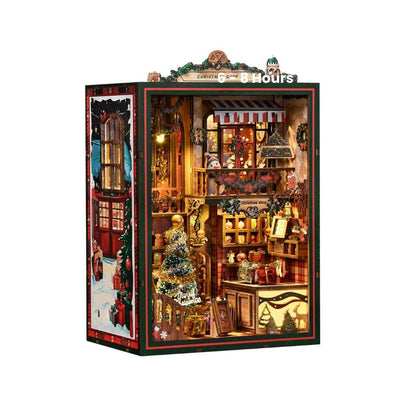 Christmas Shop book nook against a white background, showing its striped awning and festive interior.