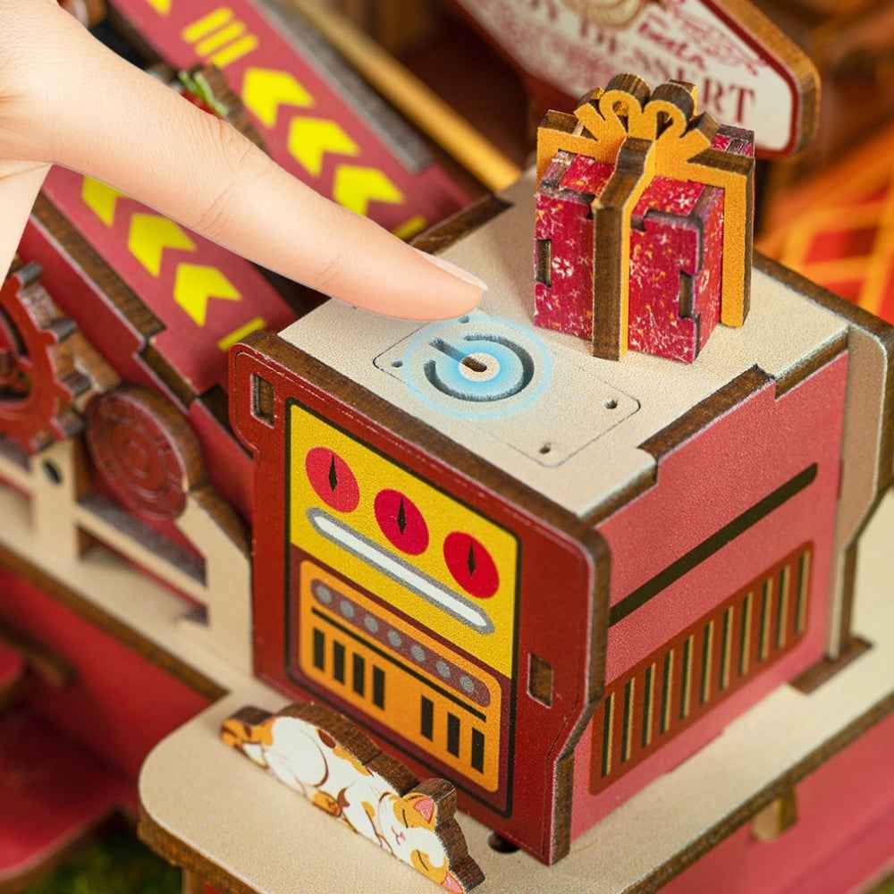 Finger pressing the Dessert Atelier control button beside a miniature present.