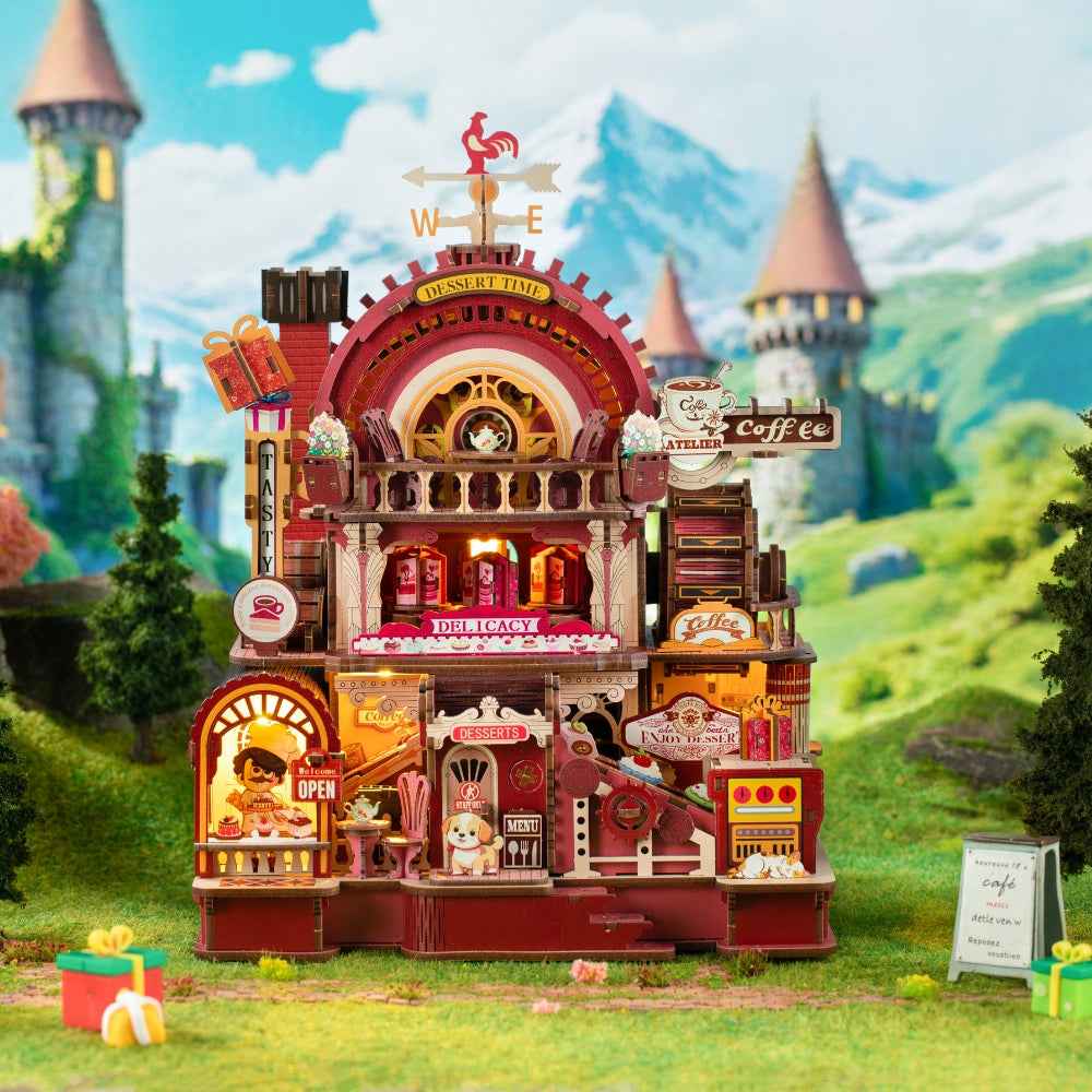 Dessert Atelier miniature shop with red-and-gold trim, display windows and a curved upper façade.
