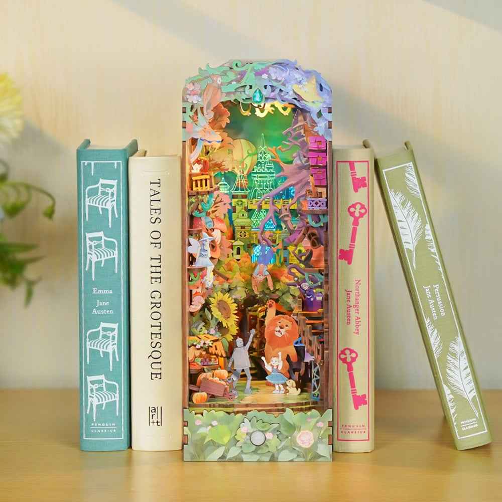 Dorothy's Journey colorful book nook between pastel books, with miniature Oz characters and flowers.