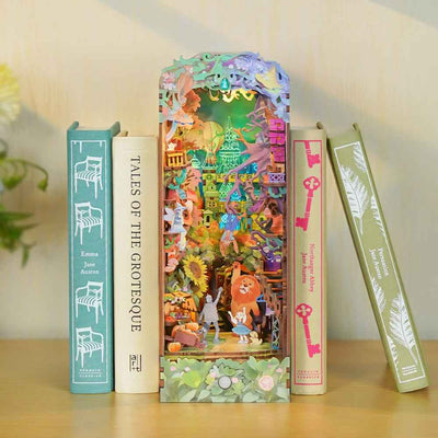 Dorothy's Journey colorful book nook between pastel books, with miniature Oz characters and flowers.