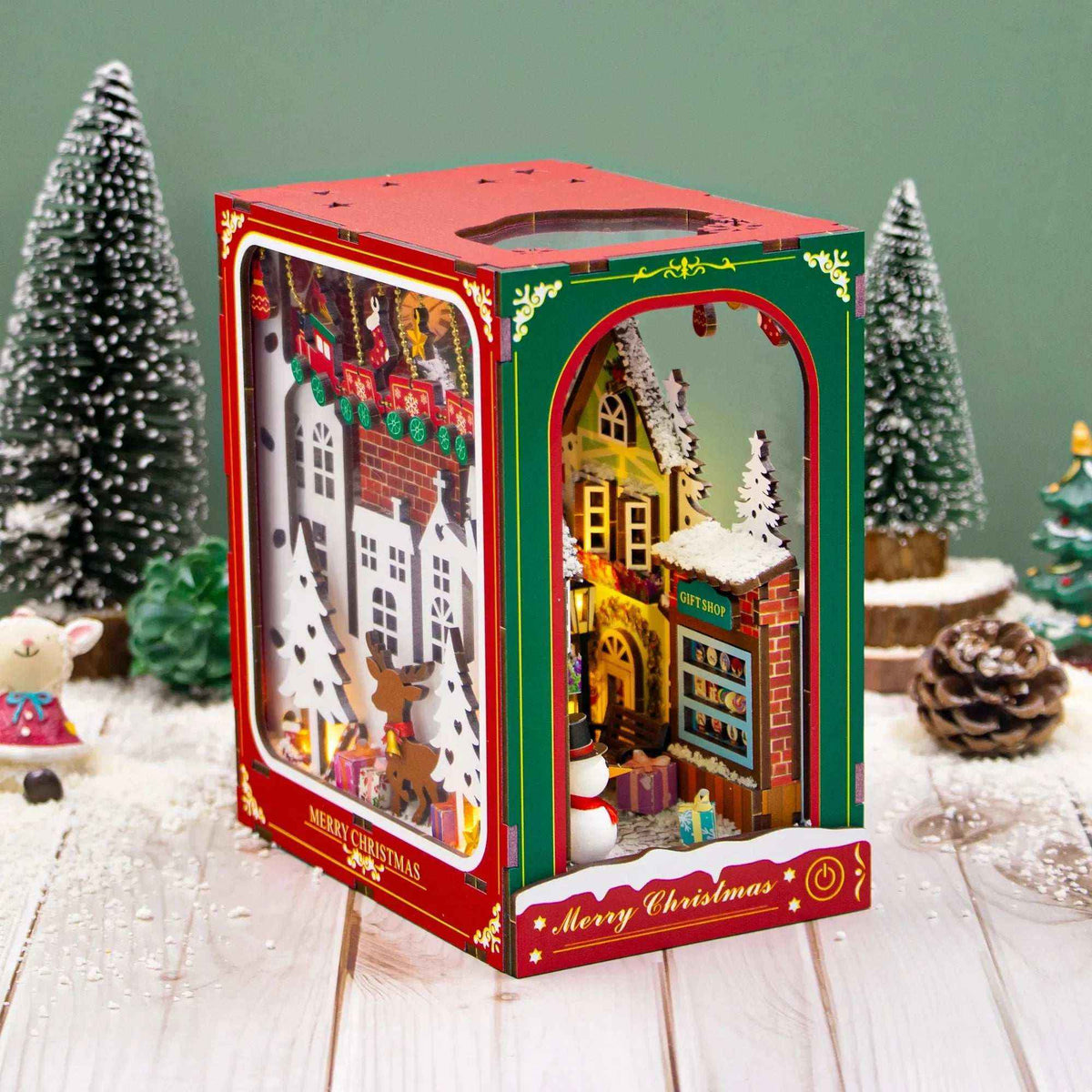 Angled Enchanted Christmas book nook showing its snowy town scene and illustrated side panel.