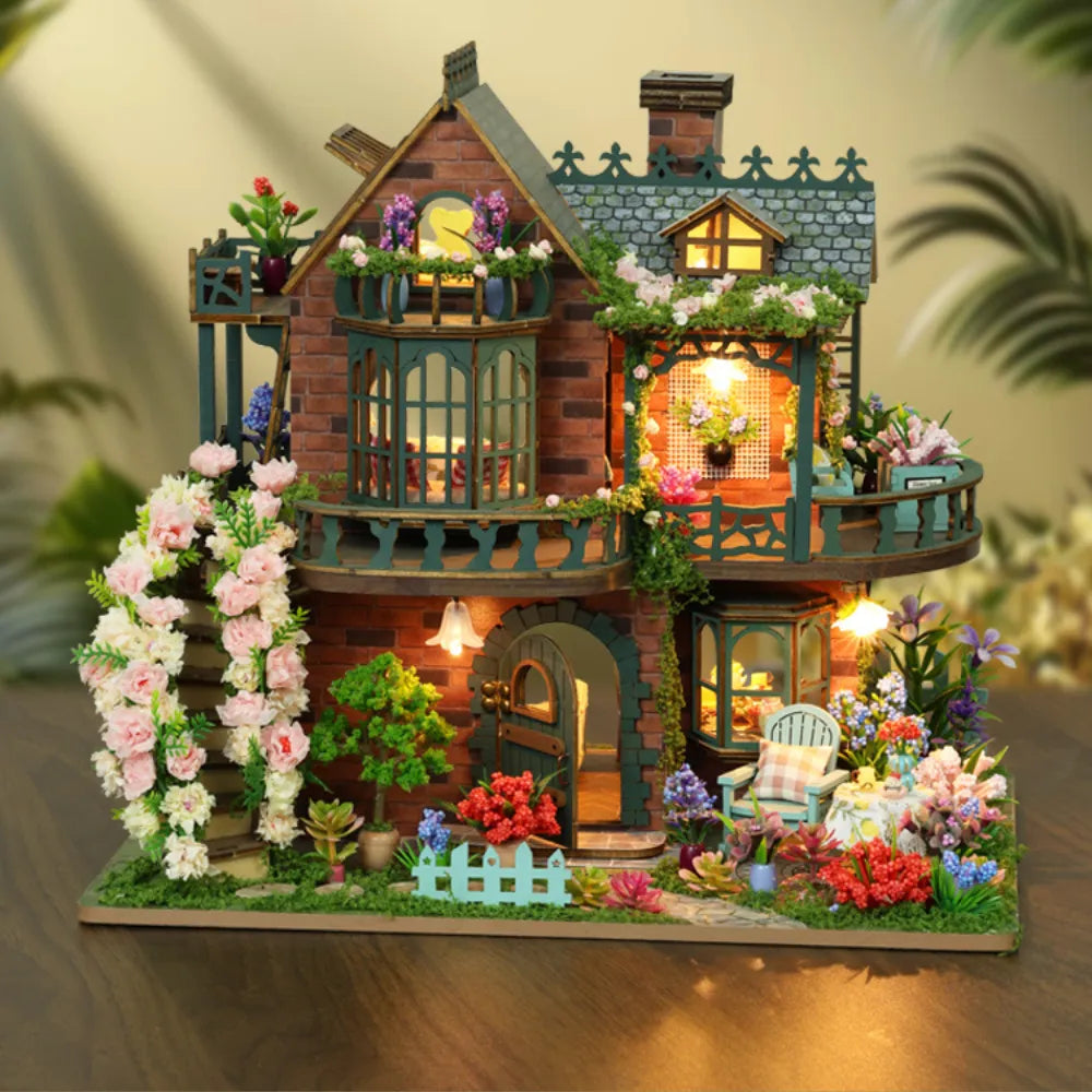 Fairy Garden miniature house with green balconies, warm-lit rooms and flowering vines.