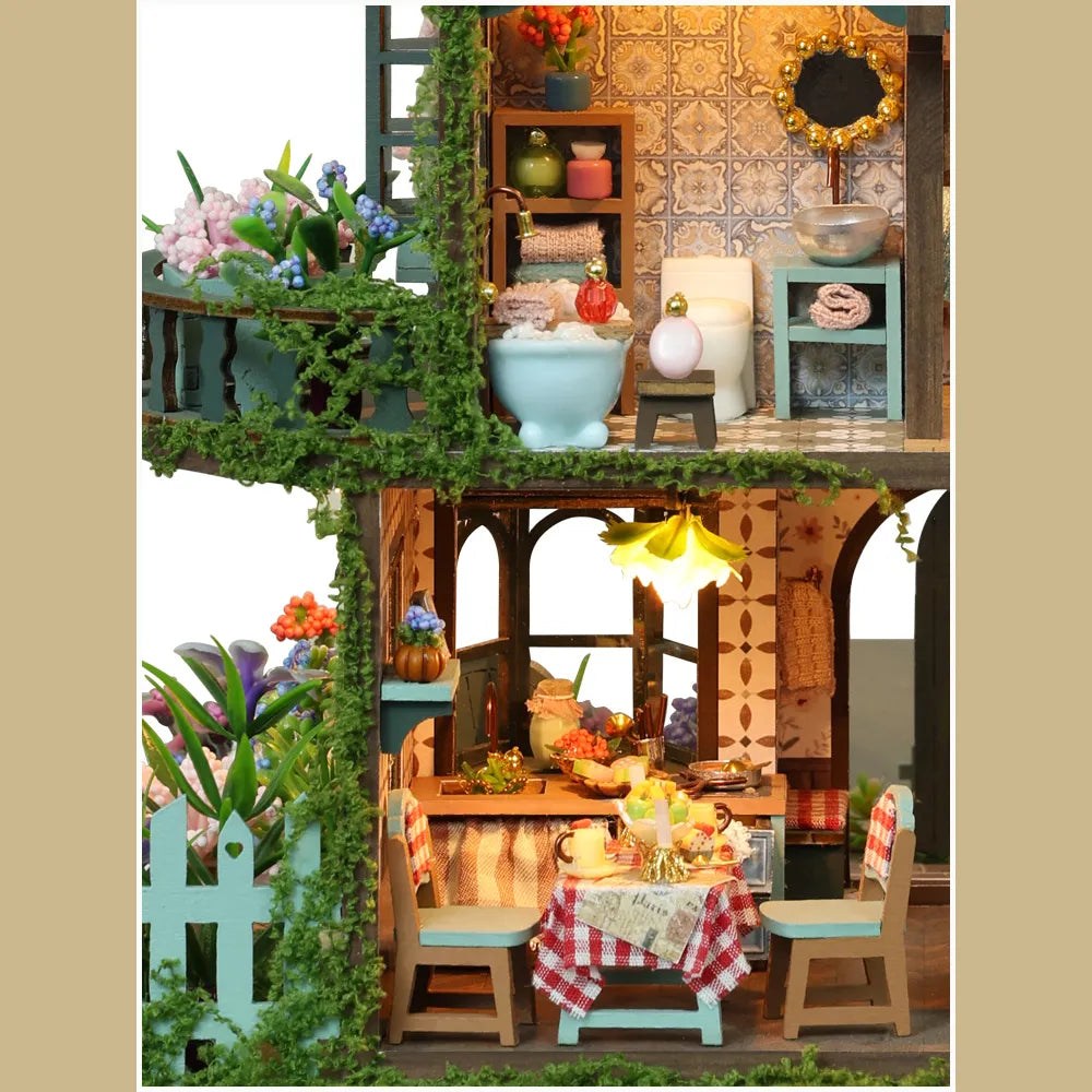 Fairy Garden details showing a miniature bathroom and an outdoor dining table.